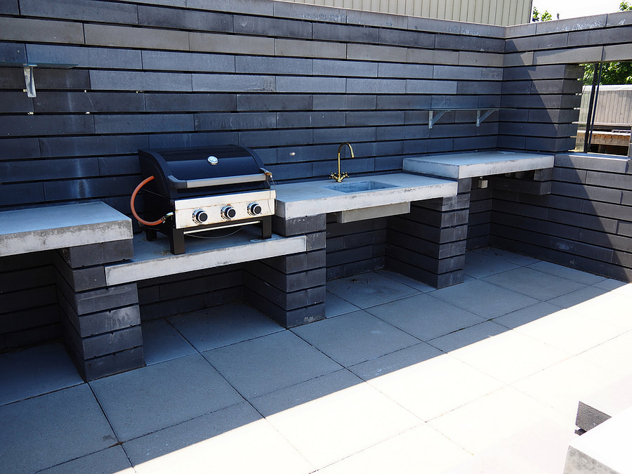 outdoor kitchen made out of black brick walls 