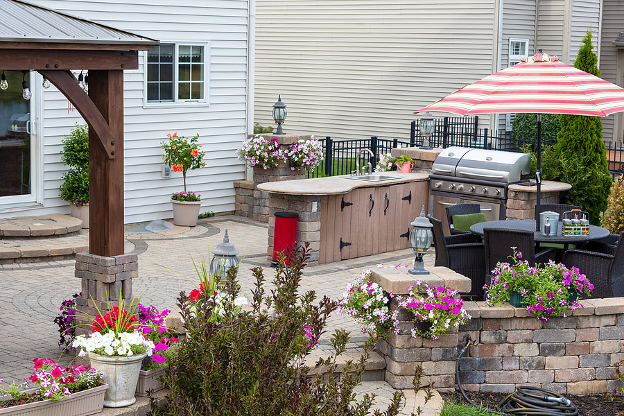 outdoor kitchen surrounded with different kinds of flowers 